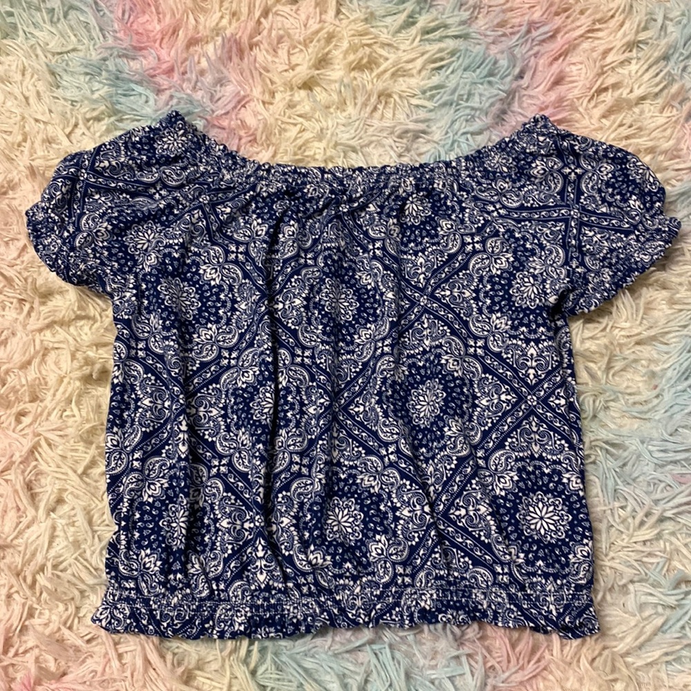 I am selling a kids, white and blue crop top.